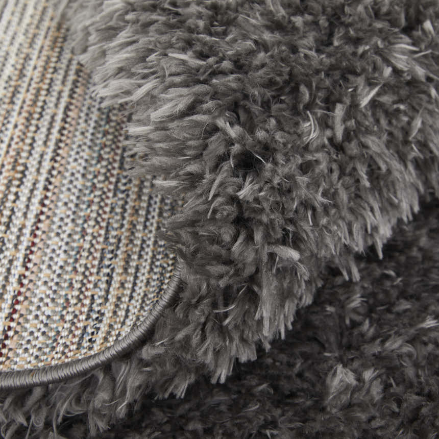 Close-up of the Feizy Darian Modern Solid Gray Area Rug showing its plush texture and backing. Fold