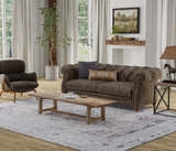 Living room scene with a Feizy Percy Tan/Ivory/Gray rug, brown sofa, and rustic wood coffee table. Roomscene-Rectangle