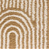 Close-up of the Calup Shag Area Rug with a geometric design in bone and brown hues. Shag texture. Styleshot
