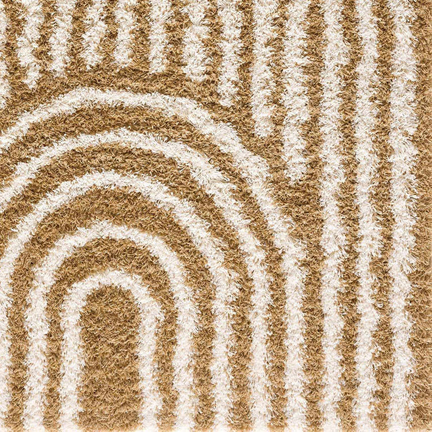 Close-up of the Calup Shag Area Rug with a geometric design in bone and brown hues. Shag texture. Styleshot