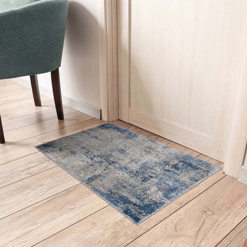 Entryway scene with Sapcote Textured Luxe Area Rug in charcoal and blue, wood floors, and teal chair. Roomscene-Rectangle