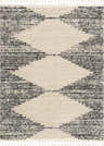Close up of the Howth Area Rug, a shag rug with a bone and dark gray diamond pattern and tassels. Design-Rectangle
