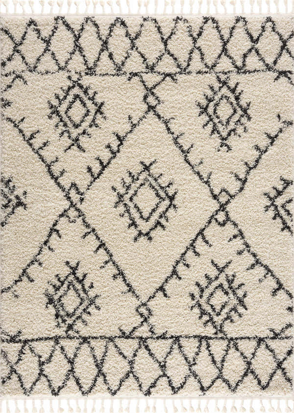 Close-up of Emlenton Berber Shag rug. Charcoal tribal pattern on light beige shag with tassels. Bohemian style. Design-Rectangle