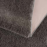 Close-up of the Judy Solid Dark Gray Washable Shag Rug showing its plush texture and durable backing. Fold