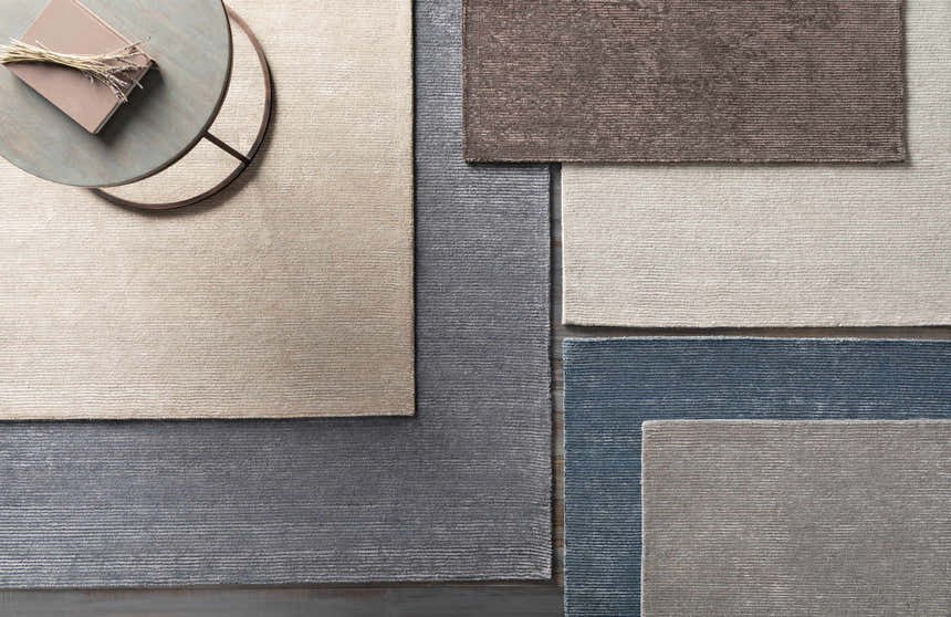 Close-up of Keller Area Rug in light gray, brown and blue, showing hand-tufted texture and striped design. Styleshot
