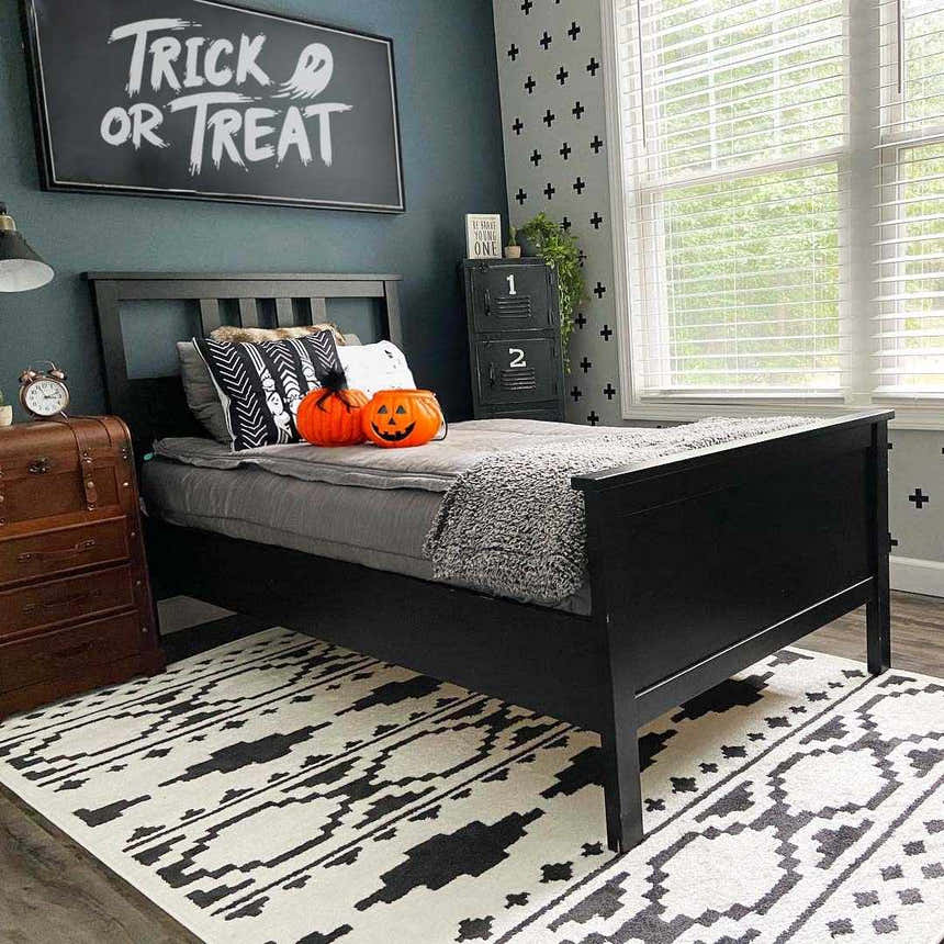 Kids bedroom with black bed, Halloween decor, and black and white Amoret Area Rug. Roomscene-Rectangle