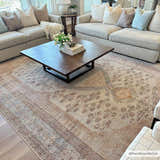 Living room scene with neutral sofas, wood coffee table, and the brown and tan Analu Non-Slip Washable Rug. Roomscene-Rectangle