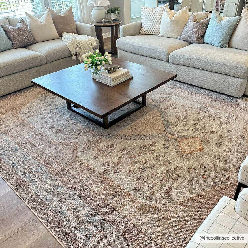 Living room scene with neutral sofas, wood coffee table, and the brown and tan Analu Non-Slip Washable Rug. Roomscene-Rectangle