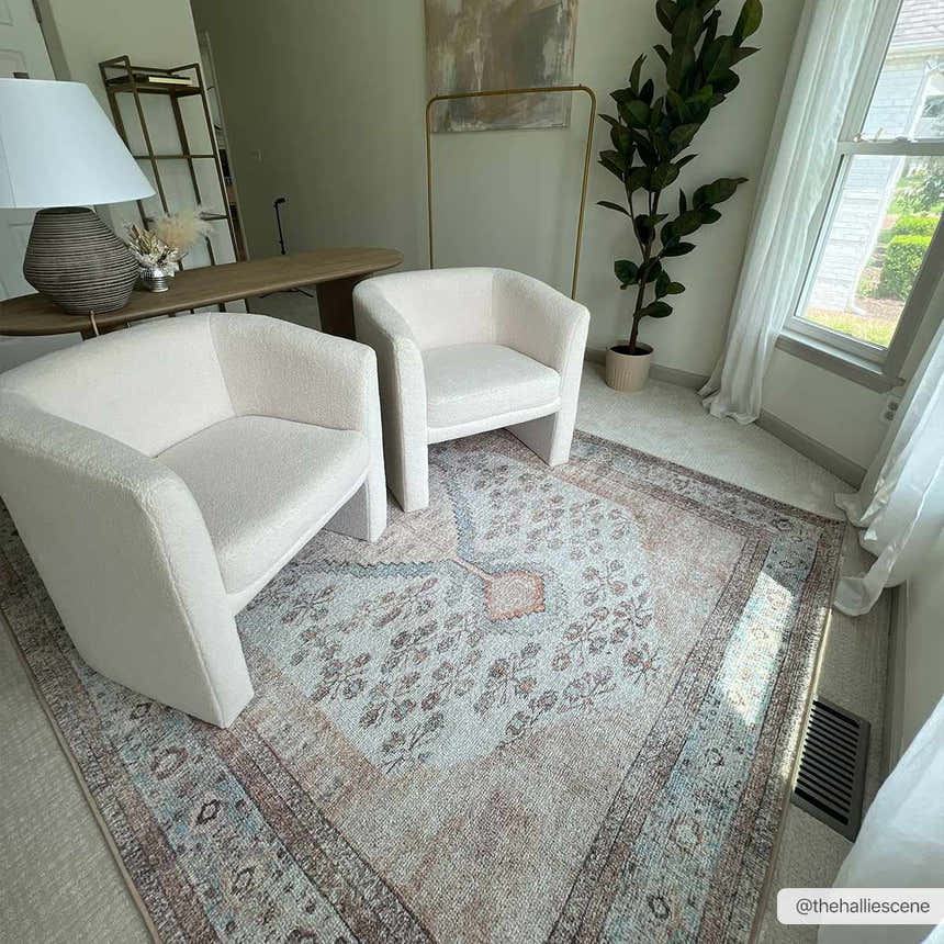 Living room scene with two white chairs on a light blue, brown, and tan Analu Non-Slip Washable Rug. Roomscene-Rectangle