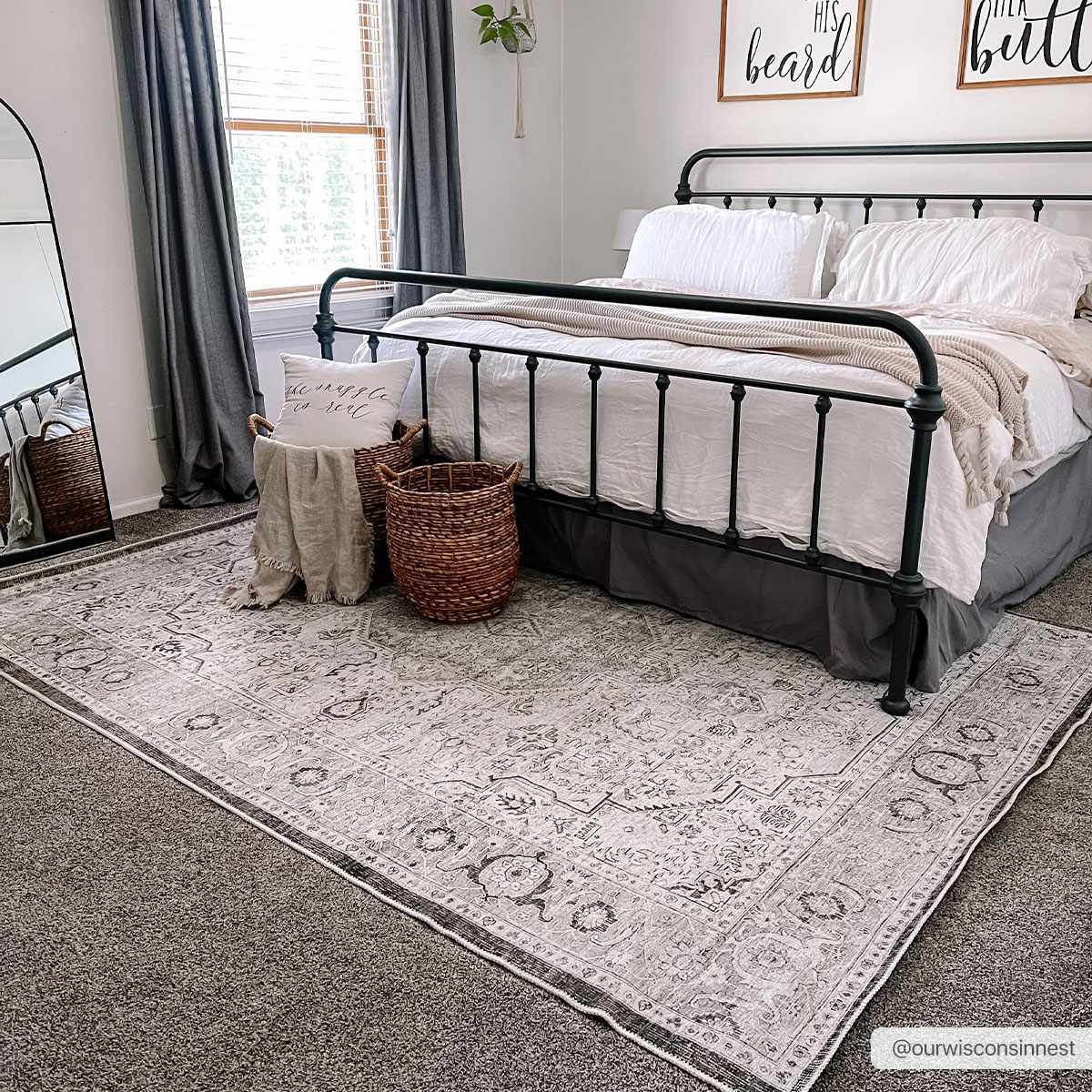 Farmhouse bedroom with a black metal bed frame and the Anzu Washable Rug in light gray and charcoal. Roomscene-Rectangle