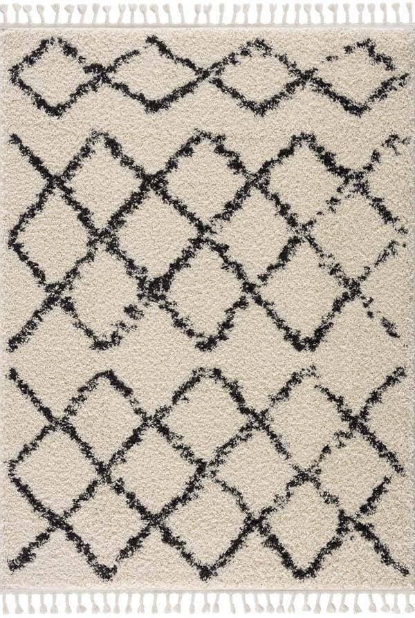 Close-up of Wallagrass Moroccan Shag Rug. Beige shag rug with charcoal geometric diamond pattern and fringe tassels. Design-Rectangle-5373