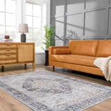 Living room with light gray Jurou Area Rug, tan leather sofa, and wood cabinet. Farmhouse style. Roomscene-Rectangle