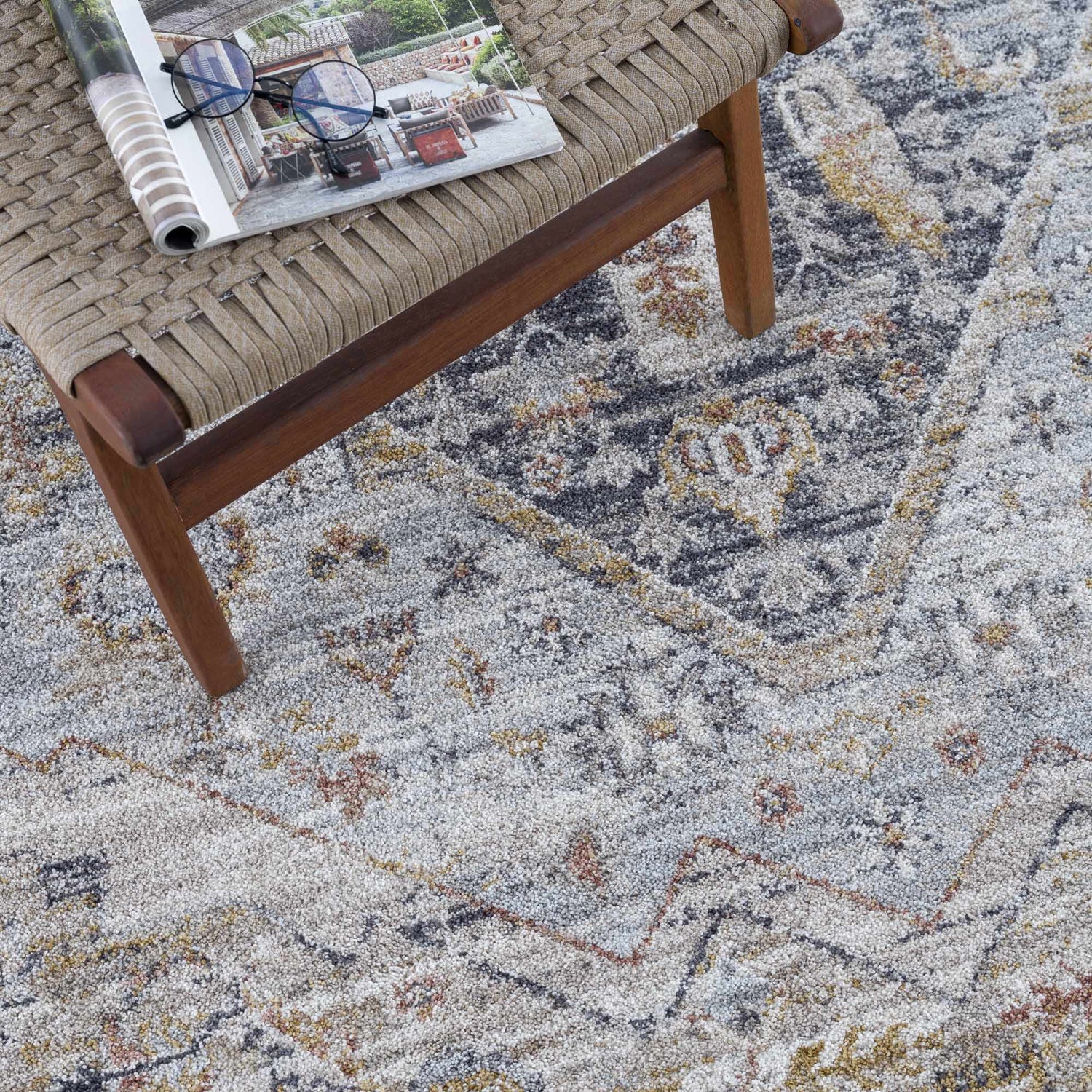 Close-up of the Jurou Area Rug in light gray and natural gray, featuring a traditional, farmhouse-style pattern and soft texture. Styleshot