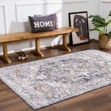 Entryway with wood bench, plant, and Ivria Navy & Rust Area Rug on wood floor. Farmhouse style. Roomscene-Rectangle