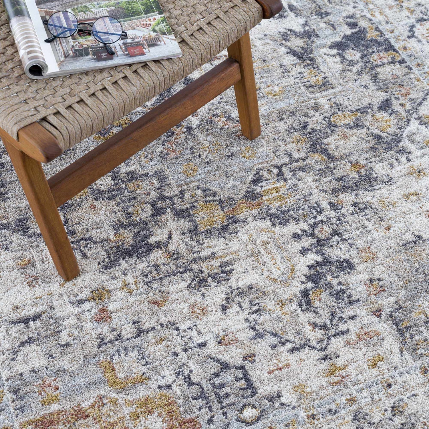 Close-up of the Ivria Navy & Rust Area Rug, showing light gray, natural gray, navy, and rust colors. Abstract pattern. Styleshot