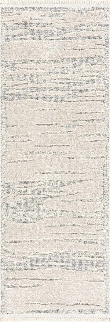 Close-up of the Lave Bone Area Rug, featuring a contemporary tone-on-tone design with bone and gray horizontal lines and fringe. Design-Runner
