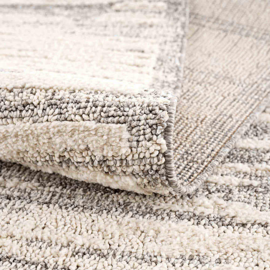 Close-up of the Lave Bone & Taupe Area Rug showing its bone and taupe striped pattern and textured, machine-woven construction. Fold