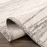 Close-up of the Lave Bone & Taupe Area Rug showing its textured weave and subtle bone and taupe striped pattern. Fold