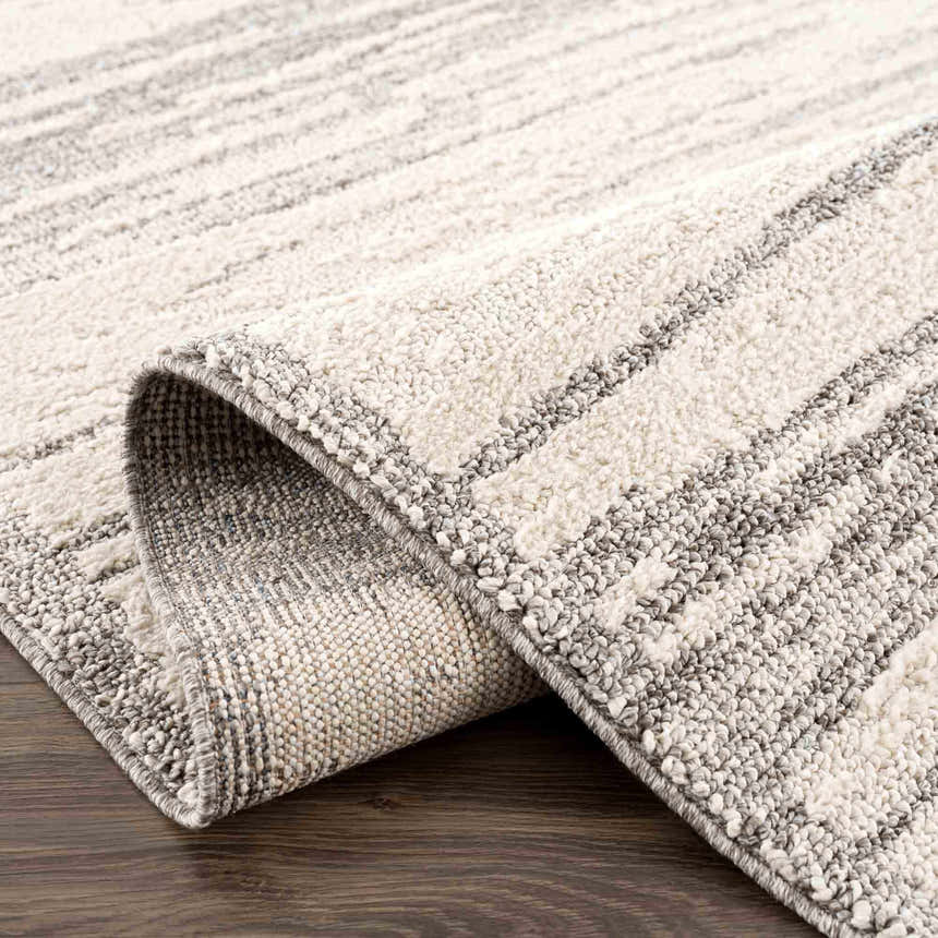 Close-up of the Lave Bone & Taupe Area Rug showing its textured weave and subtle bone and taupe striped pattern. Fold