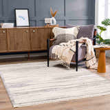 Living room scene with Lave Bone & Taupe Area Rug, gray chair, wood cabinet, and neutral decor. Contemporary style. Roomscene-Rectangle