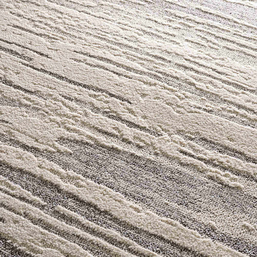 Close-up of the Lave Bone & Taupe Area Rug, showing bone and taupe striped pattern and textured, machine-woven construction. Texture