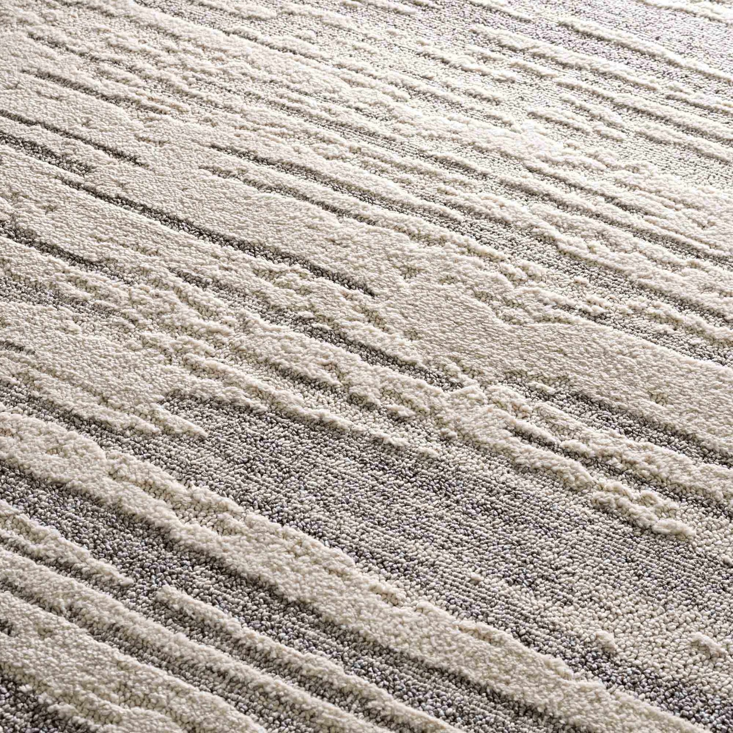 Close-up of the Lave Bone & Taupe Area Rug, showing bone and taupe striped pattern and textured, machine-woven construction. Texture