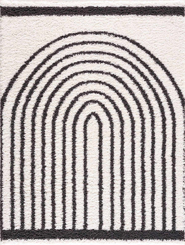 Close-up of the Bauer Plush Black Rainbow Rug, featuring a geometric black arch pattern on a soft white shag texture. Design-Rectangle-5373