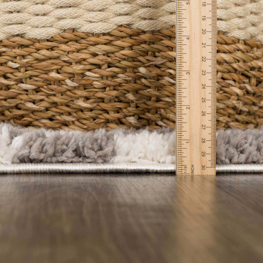 Close-up of the plush Kieu Taupe Checkered Rug showing gray and white checkered pattern and texture with a ruler. Pile