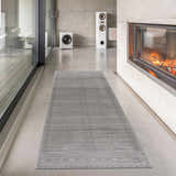 Modern living room with fireplace and Tigri Aztec Ivory & Gray area rug runner on concrete floor. Roomscene-Runner