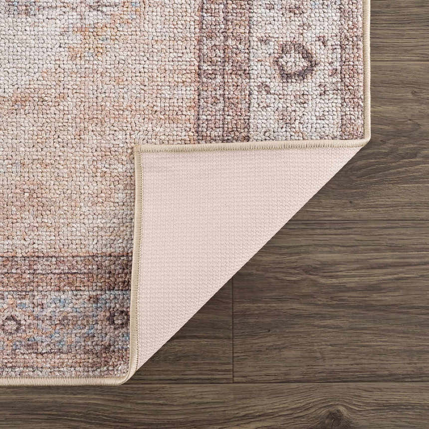 Close-up of the Analu Non-Slip Washable Rug, showing its rustic vintage pattern, brown, tan, and light blue colors, and non-slip backing. Fold