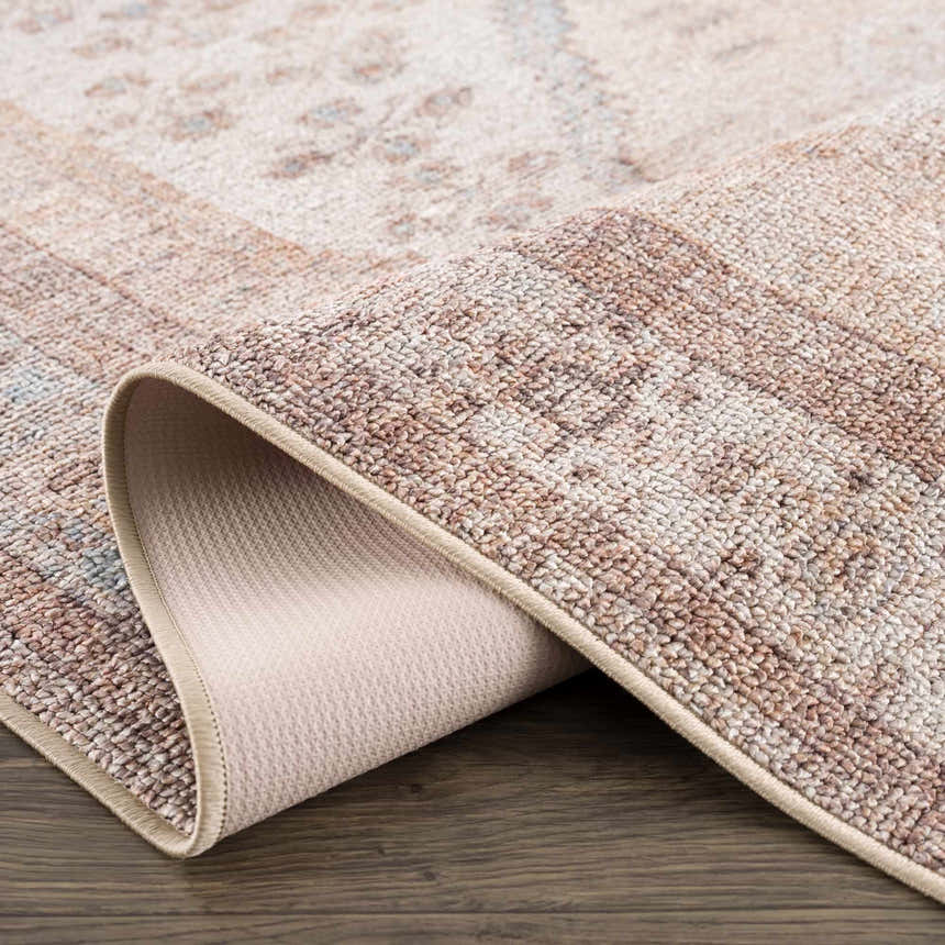 Close-up of the Analu Non-Slip Washable Rug showing its brown, tan, and light blue rustic vintage pattern and non-slip backing. Fold