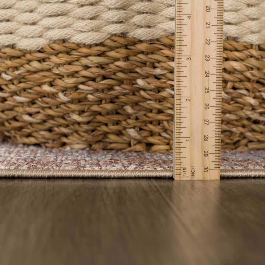 Close-up of the Analu Non-Slip Washable Rug showing its brown, tan, and light blue traditional pattern and low pile height. Pile