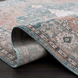 Close-up of the Edremit Area Rug showing its traditional pattern, soft texture, and colors: cream, blue, pink, and brown. Fold