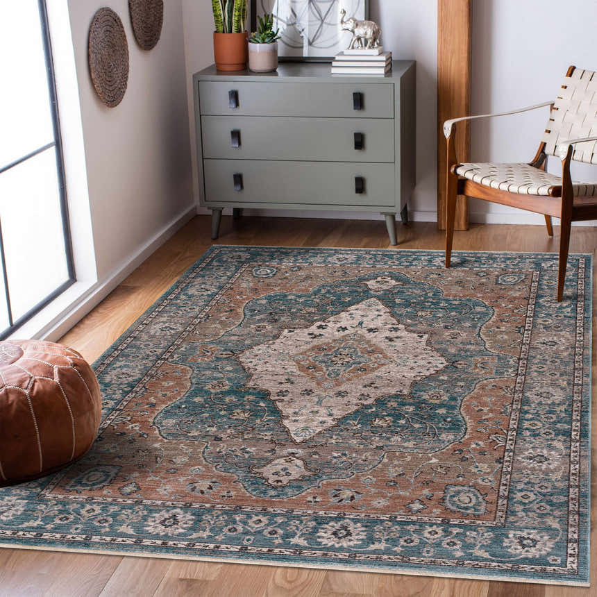 Living room scene with a cream and blue Edremit Area Rug, gray dresser, and leather pouf. Roomscene-Rectangle