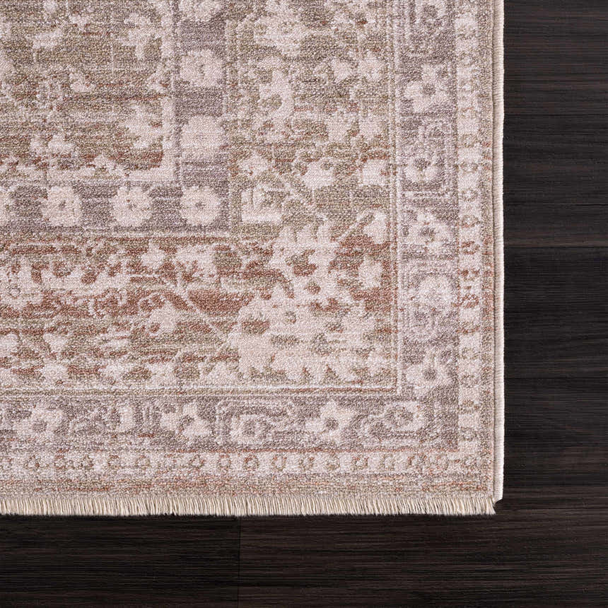 Close-up of the Kaongkod Area Rug showing its dusty pink, ivory, and brown traditional design and soft fringe. Swatch