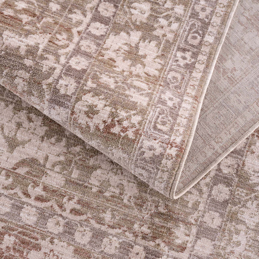Close-up of the Kaongkod Area Rug showing its traditional oriental pattern and texture in dusty pink, ivory, and brown tones. Fold