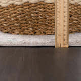 Close-up of Bolitoc Area Rug showing pile height against a wooden ruler and woven basket. Pile