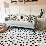 Girly bedroom scene with a Cansu Black & White Dotted Area Rug, gray sofa, and fun pillows. Roomscene-Rectangle