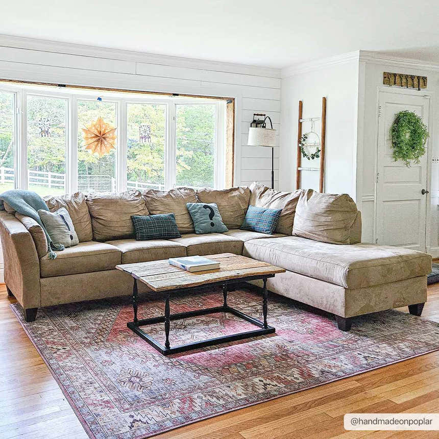 Living room scene with a beige sectional sofa on a pink and gray Chadwicks Area Rug. Farmhouse style decor. Roomscene-Rectangle