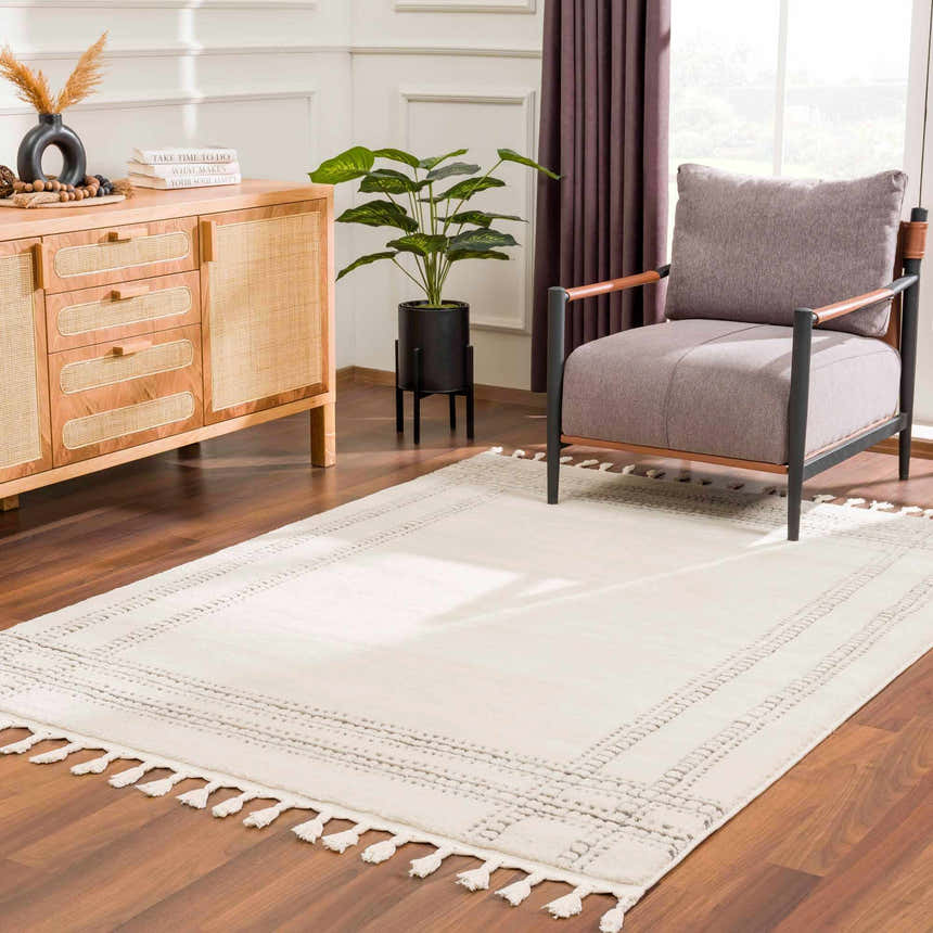 Living room scene with a Ryuu Ivory & Gray Area Rug, wood cabinet, gray chair, and plant near a window. Contemporary style. Roomscene-Rectangle