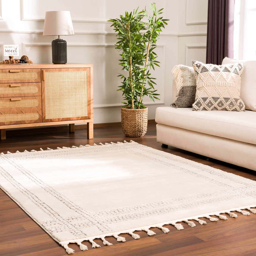 Living room scene with Ryuu Ivory & Gray Area Rug, sofa, wood cabinet, and plant. Neutral tones create a calm, inviting mood. Roomscene-Rectangle