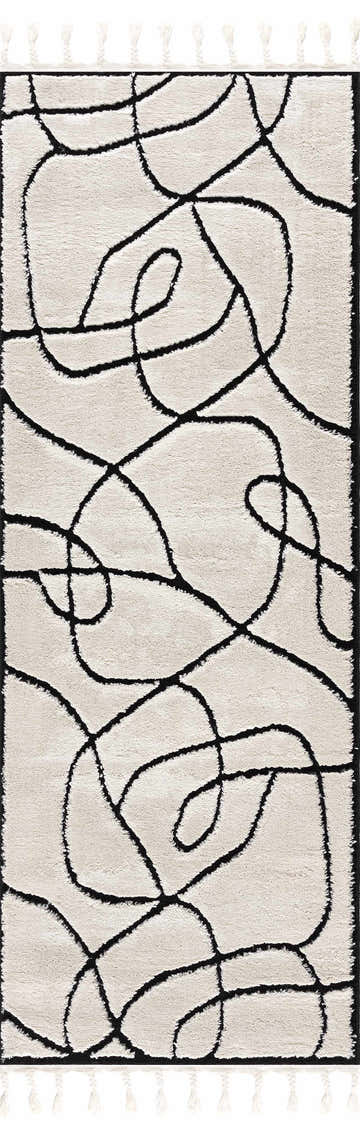 Close-up of the Azana Black & White Area Rug featuring a geometric, high-low design and decorative tassels. Design-Runner