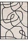 Close-up of the Azana Black & White Area Rug featuring a bold, abstract geometric design and soft, textured pile. Design-Rectangle-46