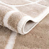 Close-up of the plush Azana Cream Area Rug showing its geometric pattern and soft, textured pile. Fold