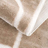 Close-up of the Azana Cream Area Rug showing the soft texture, geometric pattern, and durable backing. Fold