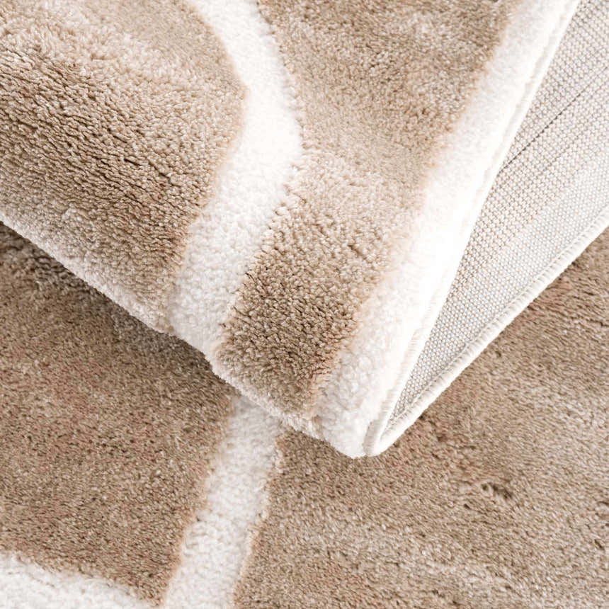 Close-up of the Azana Cream Area Rug showing the soft texture, geometric pattern, and durable backing. Fold
