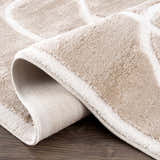Close-up of the Azana Cream Area Rug showing its geometric pattern, plush texture, and durable backing. Fold