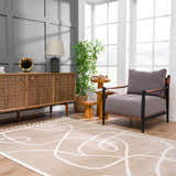 Living room scene with a cream Azana Area Rug featuring an abstract design, wood cabinet, and gray chair. Roomscene-Rectangle
