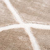 Close-up of the Azana Cream Area Rug showing the geometric pattern and soft, textured polypropylene material. Texture