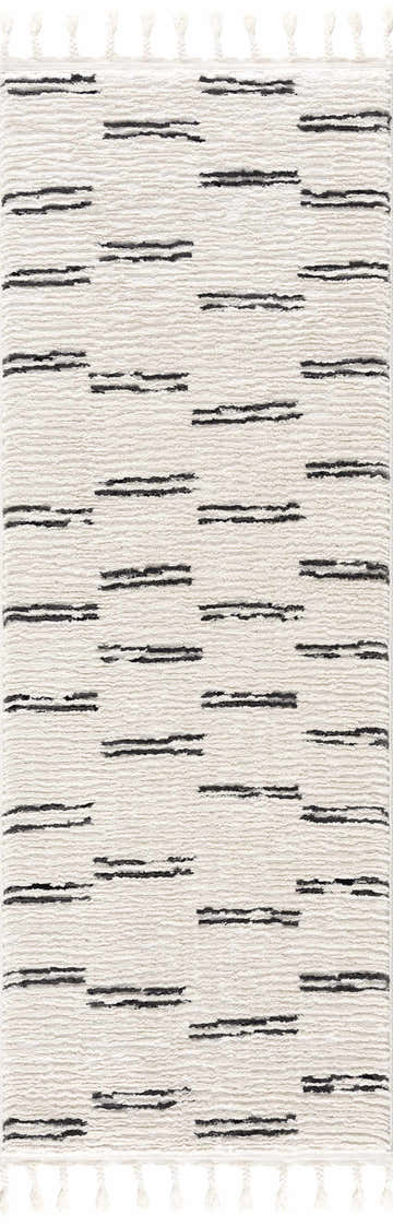 Close-up of the Riad Black Striped White Rug with Tassels. Features a geometric black stripe pattern on a textured beige rug. Design-Runner